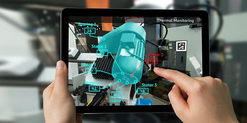 An engineer using a VR headset for industrial training in a simulated factory environment.